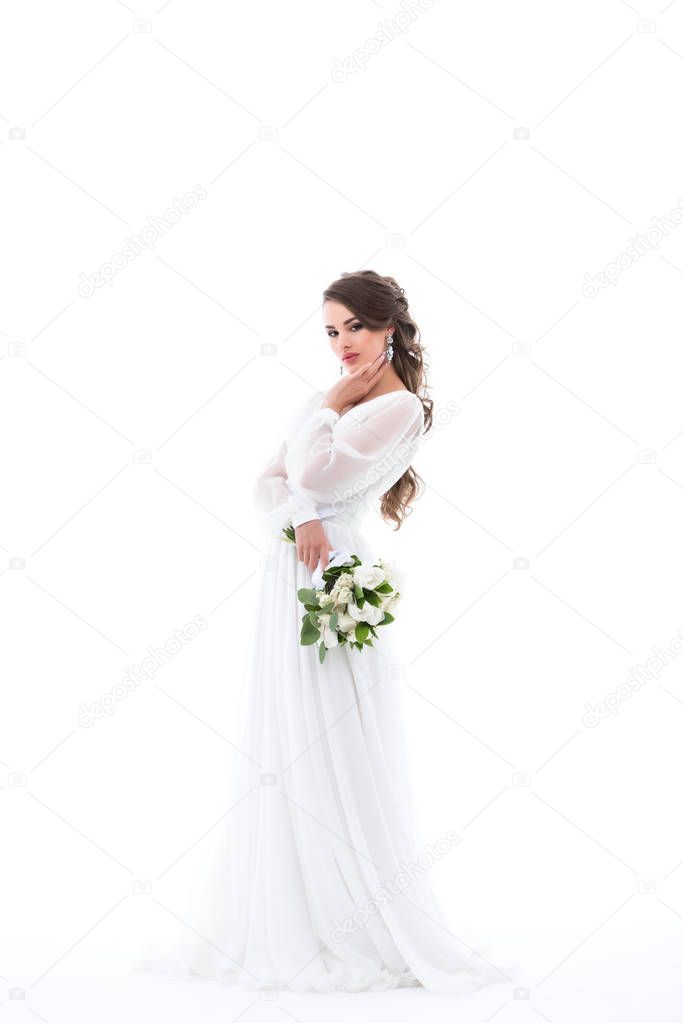 elegant bride posing in white dress with wedding bouquet, isolated on white