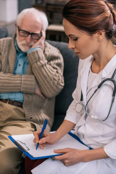 Doctora Anotando Quejas Médicas Pacientes Mayores — Foto de Stock