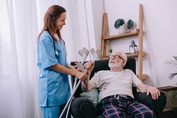 Verpleegkundige Krukken Geven Senior Mannelijke Patiënt — Stockfoto