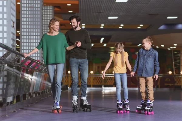 Parents and kids skating on roller rink together — Stock Photo, Image