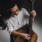 High angle view young man playing standup bass