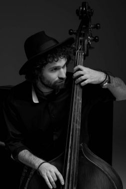 black and white shot of handsome musician playing standup bass clipart