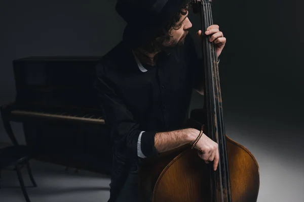 Young handsome musician playing contrabass — Stock Photo, Image