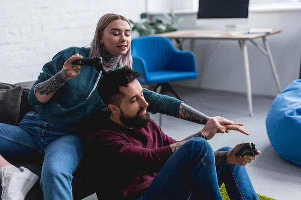 Tattooed Girlfriend Reaching Hand Boyfriends Gamepad — Free Stock Photo