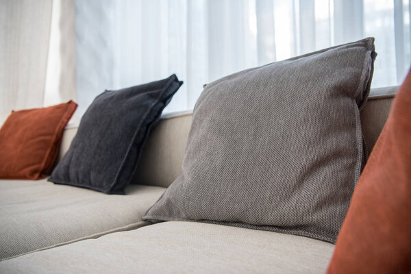 Closeup view of multicolor pillows on couch 