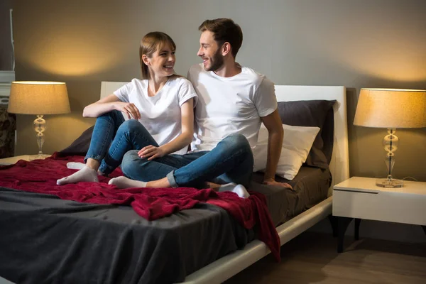 Happy Young Couple Sitting Bed Cozy Modern Bedroom — Stock Photo, Image