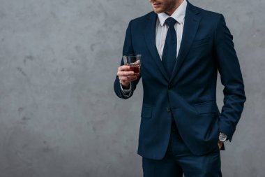 cropped shot of handsome businessman with glass of whiskey clipart
