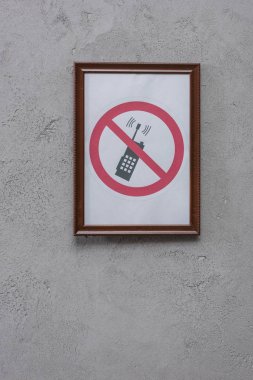 restricted phone placard on concrete wall clipart