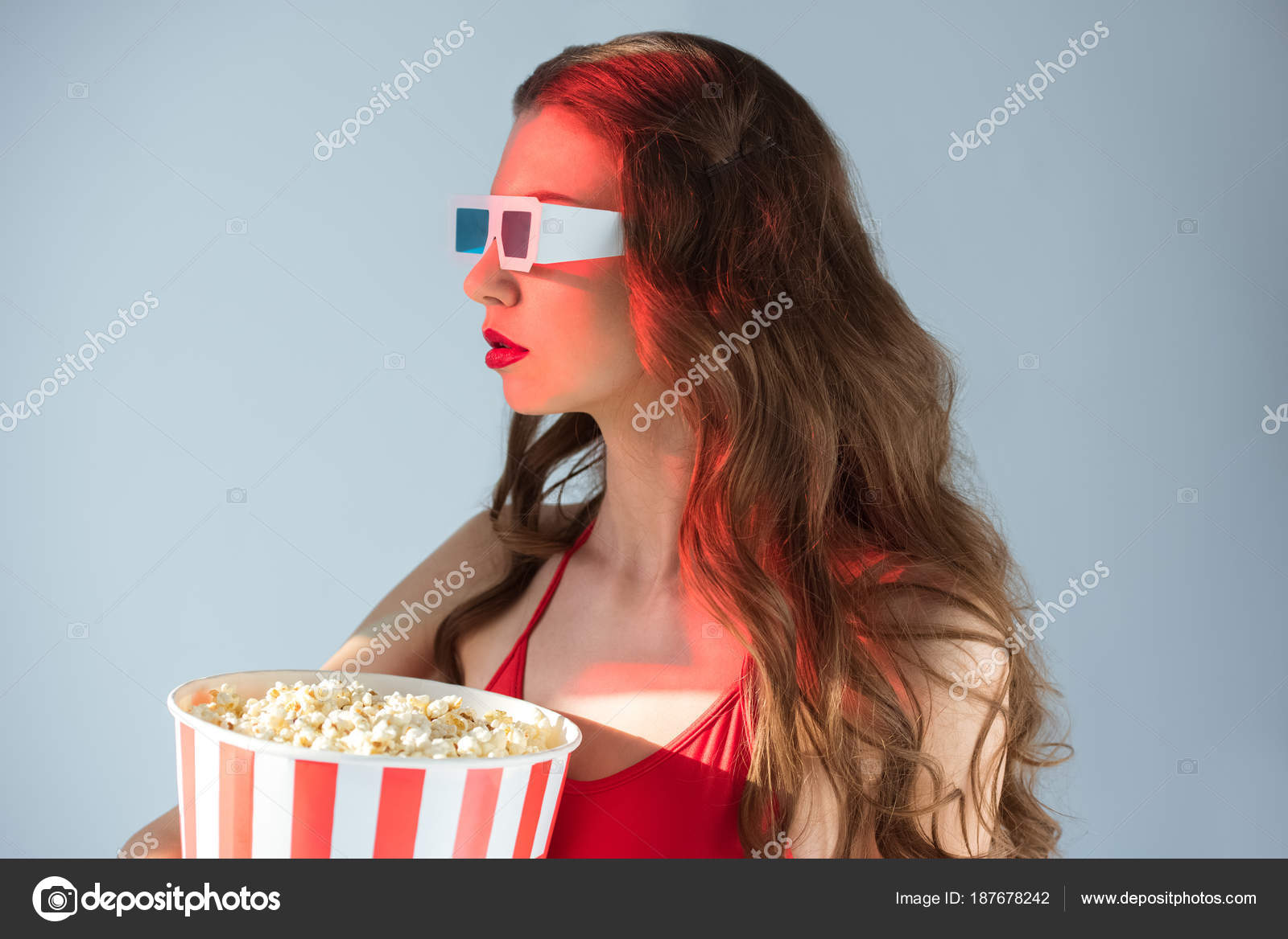 side view seductive girl glasses holding popcorn isolated grey