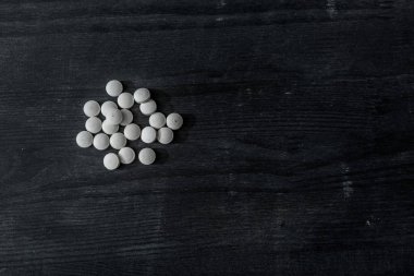 top view of mdma pills on black wooden surface clipart