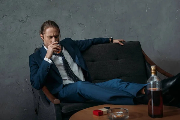 Young Alcohol Addicted Businessman Drinking Whiskey While Sitting Couch — Stock Photo, Image