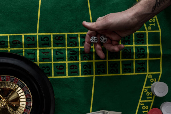top view of man gambling on roulette at casino, gambling addiction concept