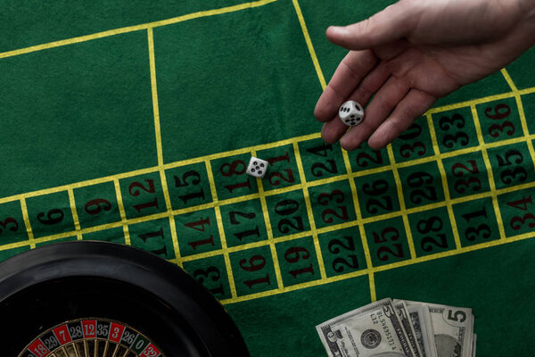 top view of man gambling on roulette at casino, gambling addiction concept