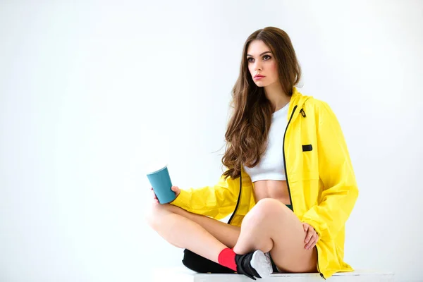 Sexy Girl Yellow Jacket Shorts Sitting Cube Holding Drink Isolated — Stock Photo, Image