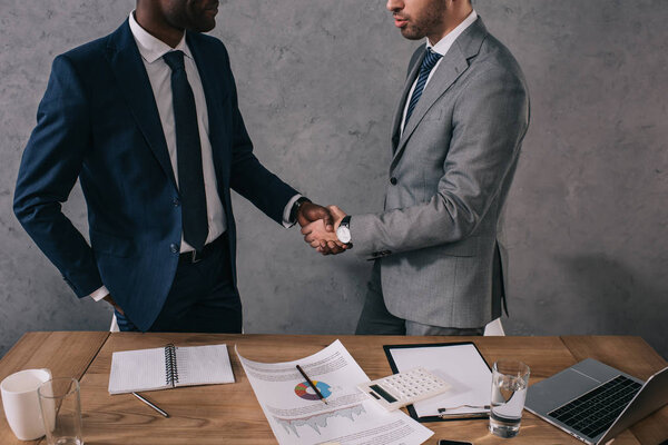 Cropped view of two businessmen shaking hands of each other 