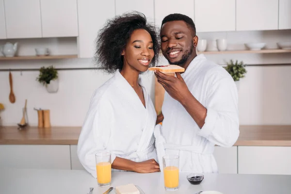 Smiling African American Couple Eating Toast Jam Kitchen — Stock Photo, Image