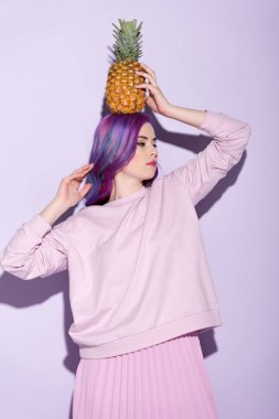 beautiful young woman in pink sweatshirt holding pineapple on head clipart