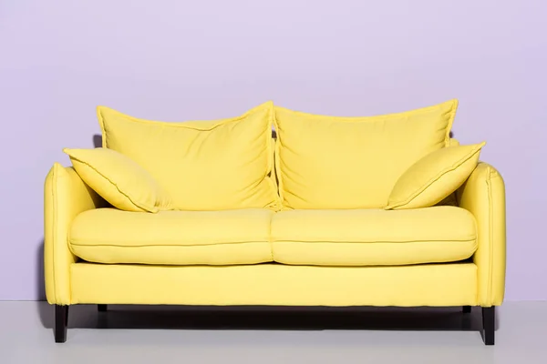 Comfy Yellow Couch Front Pink Wall Royalty Free Stock Photos