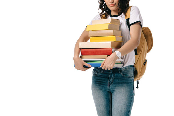 cropped image of african american teen student holding stack of books isolated on white