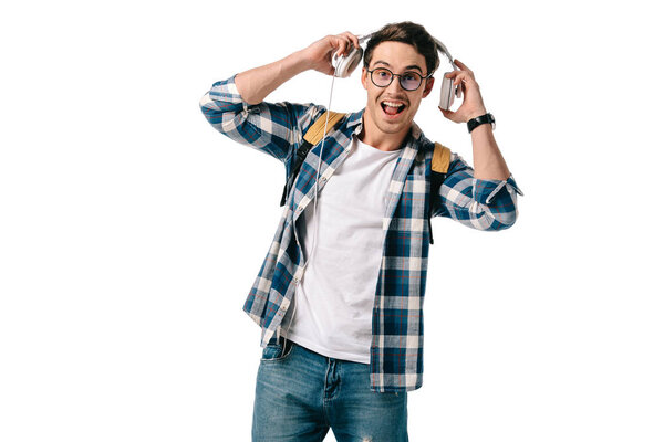 happy handsome student listening to music isolated on white