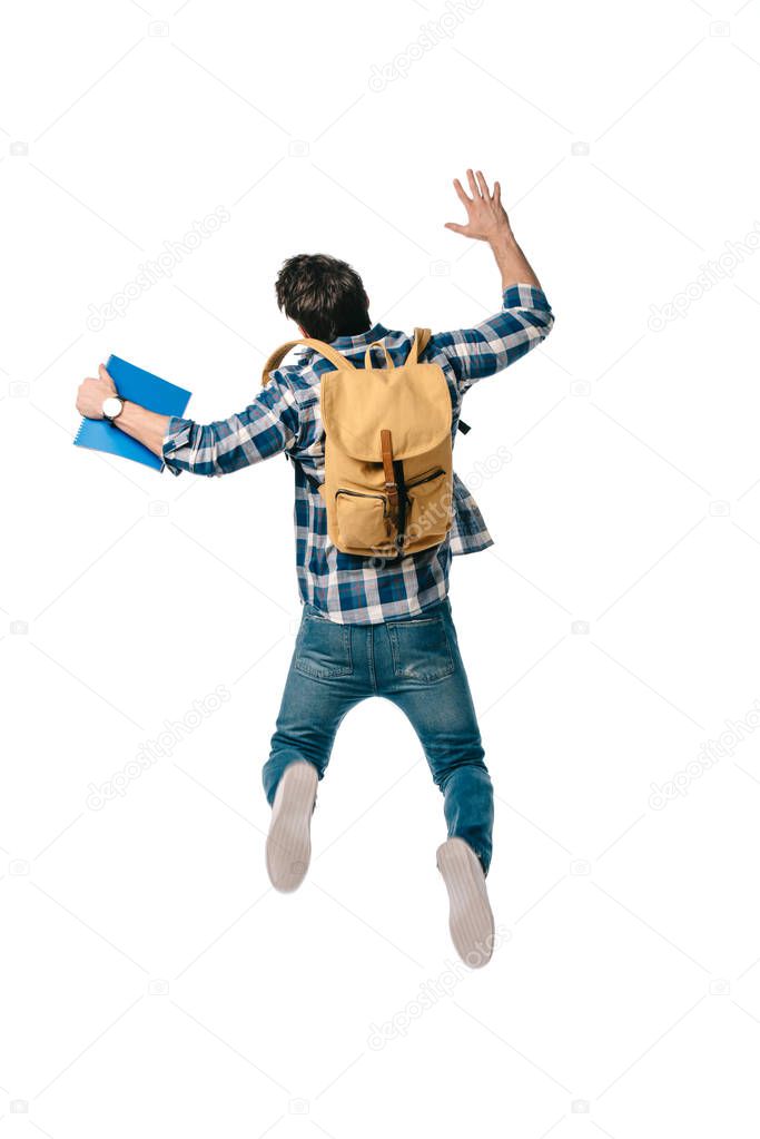 back view of student jumping with backpack and copybook isolated on white