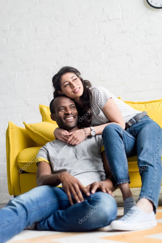 happy african american couple spending time together at living room