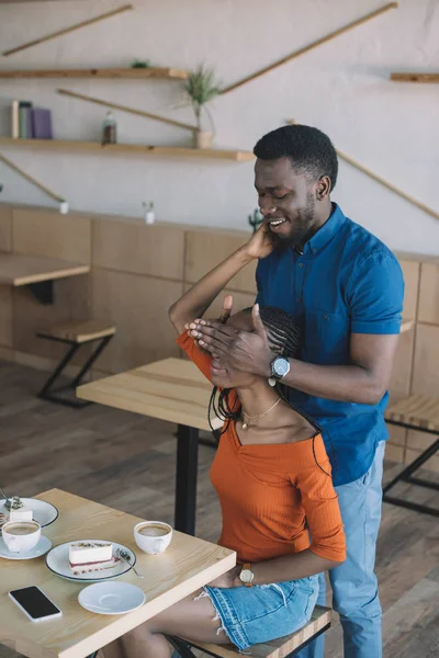 African American Man Covering Girlfriends Eyes Surprise Her Coffee Shop — Stock Photo, Image