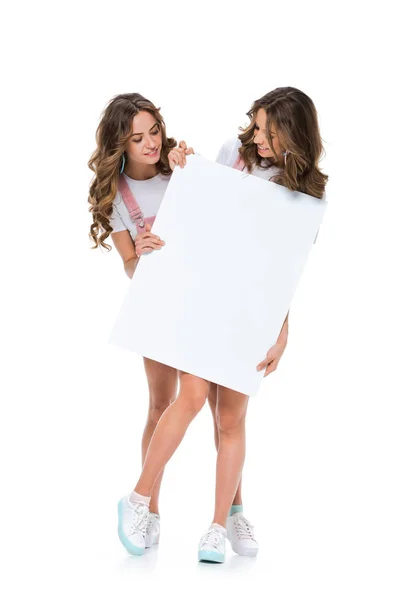 Attractive Young Twins Looking Empty Board Isolated White — Stock Photo, Image