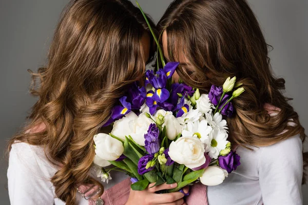 Twins Covering Faces Bouquet Isolated Grey — Stock Photo, Image