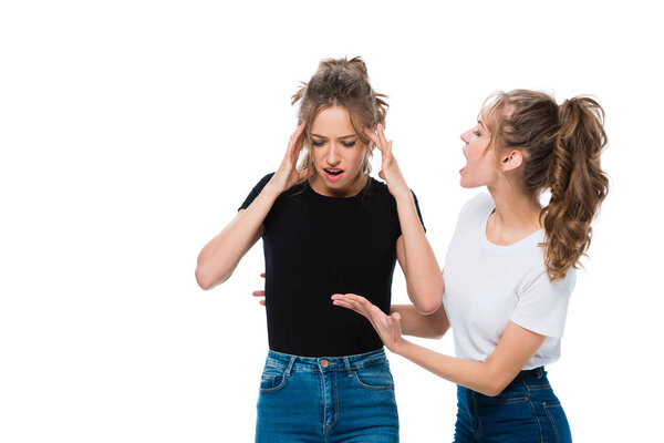 Twin screaming at sister isolated on white
