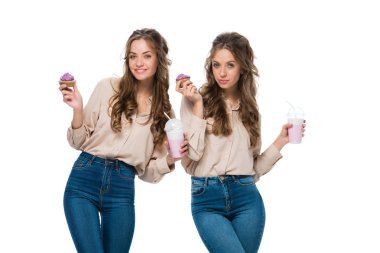 attractive young twins with cupcakes and milkshakes isolated on white clipart