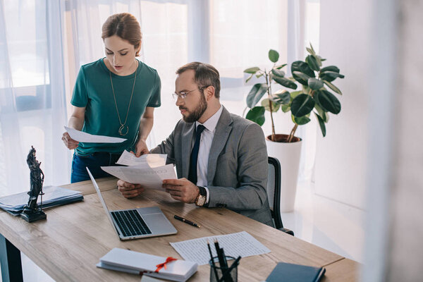 lawyer and client discussing contract at workplace in office