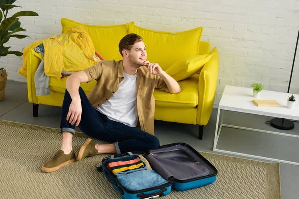 Handsome Dreamy Man Sitting Floor Travel Bag — Free Stock Photo