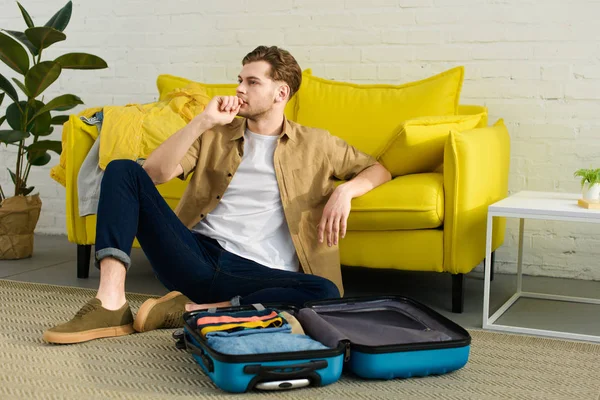 Handsome Pensive Man Sitting Floor Sofa Travel Bag — Stock Photo, Image