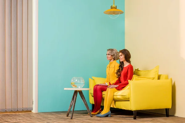 Retro Styled Women Sitting Yellow Sofa Aquarium Fish Coffee Table — Stock Photo, Image