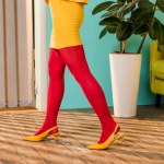 Cropped shot of woman in bright clothing standing at colorful room, doll house concept