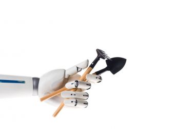 robot hand holding garden hoe and shovel isolated on white clipart