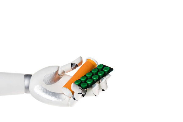 robot hand holding bottle and blister with pills isolated on white