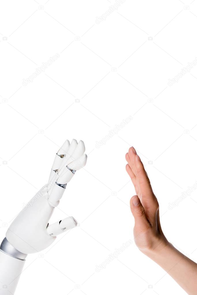 cropped shot of robot and human making high five gesture isolated on white