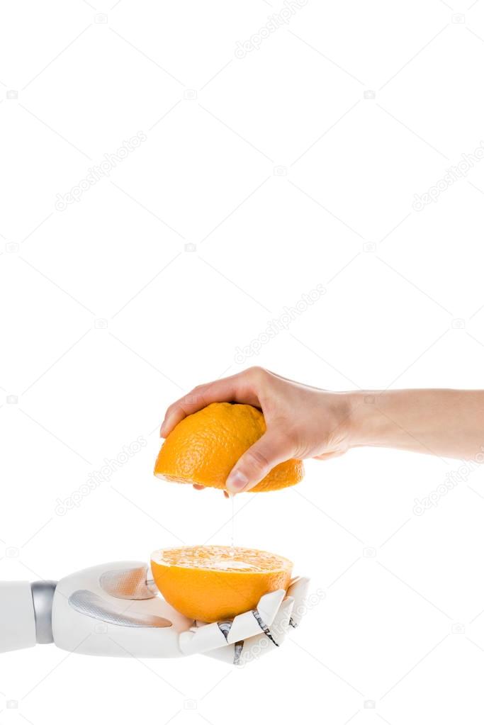 cropped shot of robot and human with halves of orange isolated on white