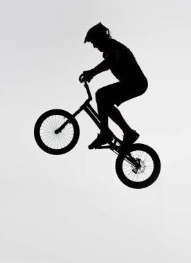 silhouette of trial biker jumping on bicycle on white clipart