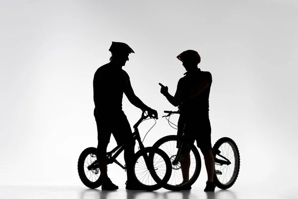 Silhouettes Trial Bikers Bicycles Chatting White — Stock Photo, Image
