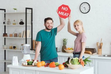 couple of vegans showing no meat sign at kitchen clipart
