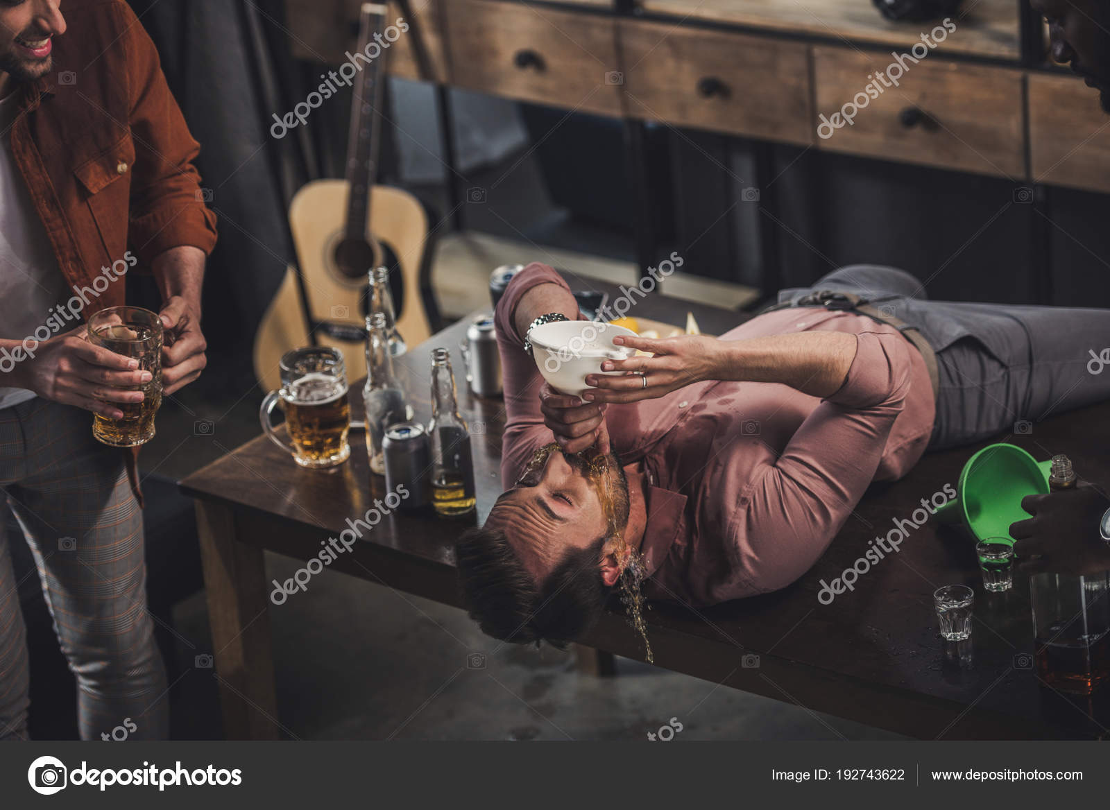 Young Man Lying Table Drinking Beer Funnel While Friends Looking Stock ...