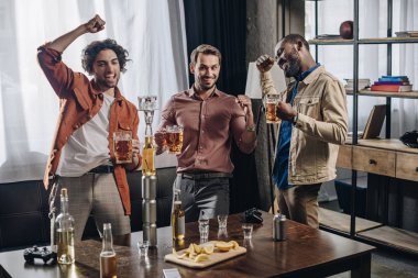 happy male friends cheering and drinking beer together clipart