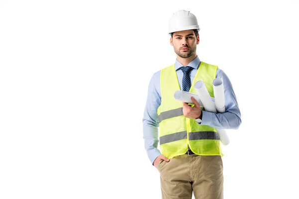 Handsome architect in reflective vest and helmet holding blueprints isolated on white