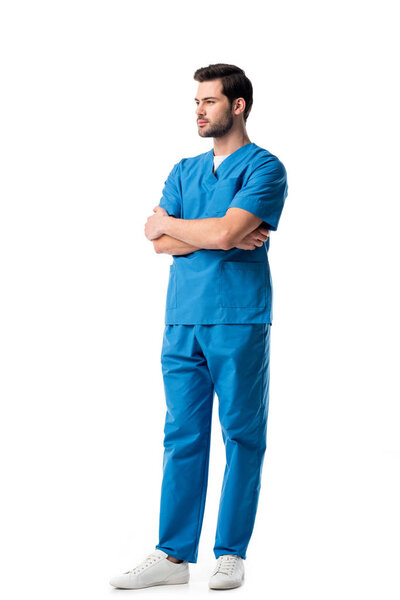 Handsome male nurse wearing blue uniform isolated on white