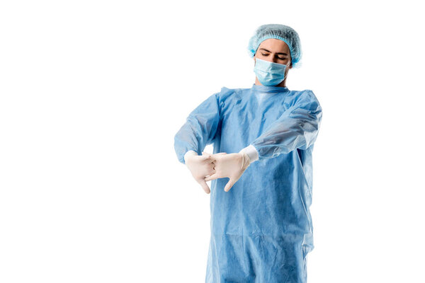Surgeon wearing blue uniform stretching his hands isolated on white