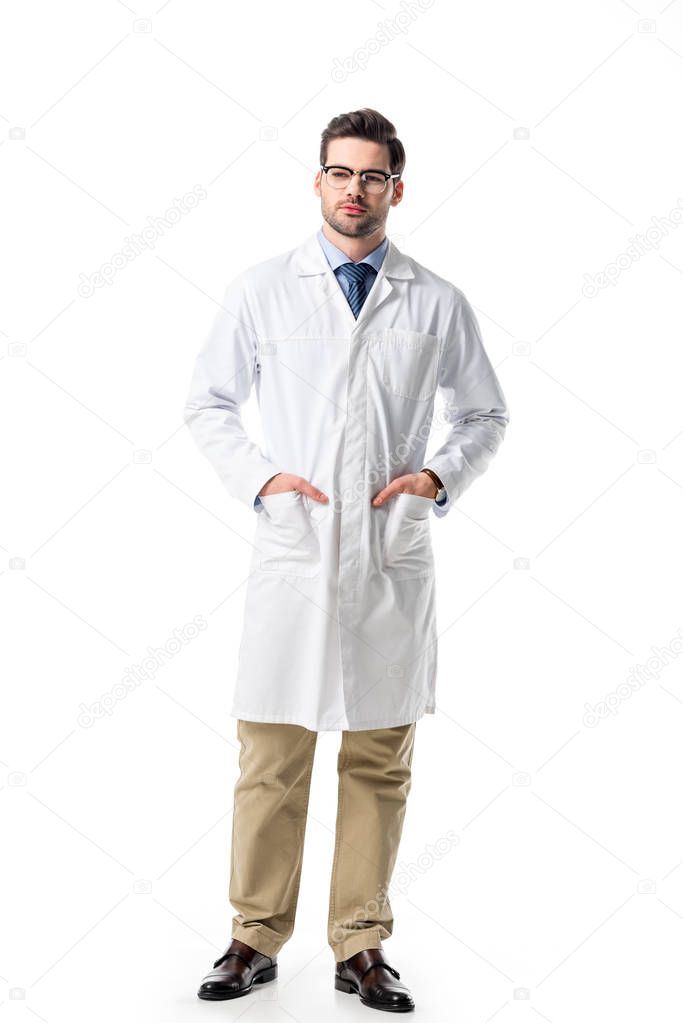 Handsome doctor in glasses wearing white coat isolated on white