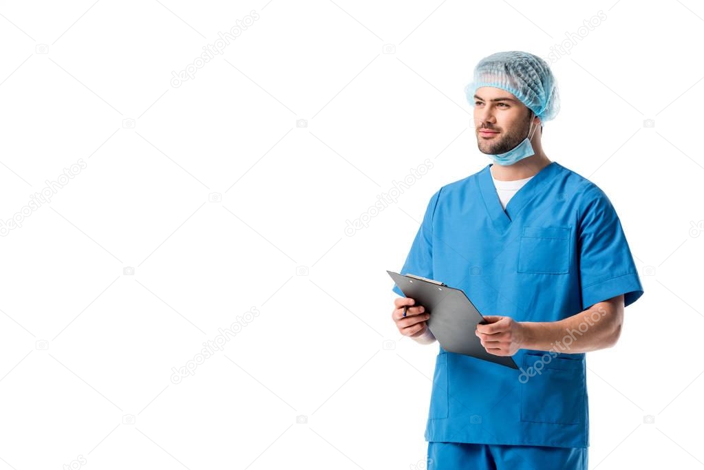 Surgeon wearing blue uniform and writing diagnosis in clipboard isolated on white